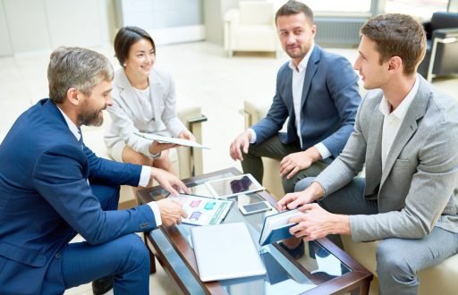 team-of-cheerful-business-people-in-meeting-e1619632345114